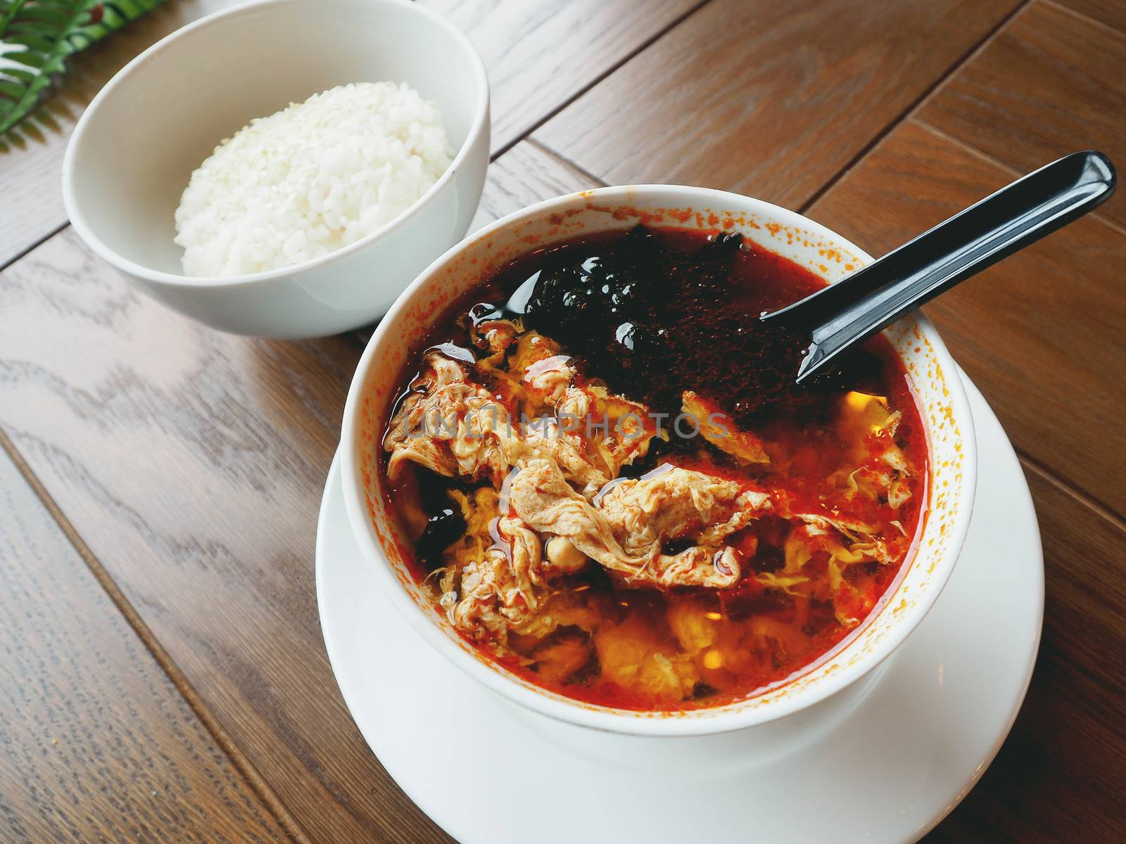 Asian cuisine - Kimchi soup in white bowl with rice. Close up photo.