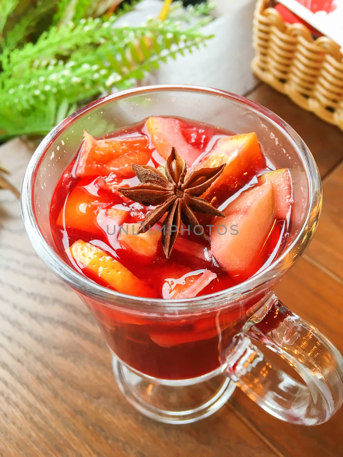 Glass of mulled wine with grapefruit, orange crusts and star anise or illicium seeds. Warming drink with or without alcohol.