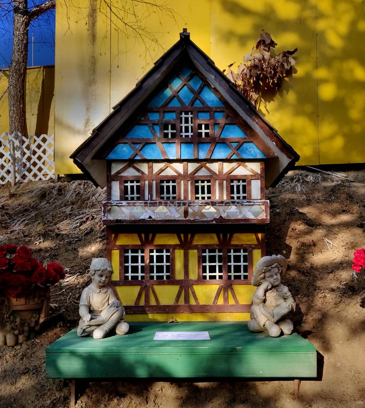 Wooden doll house with two angelic girls sitting in front by mshivangi92