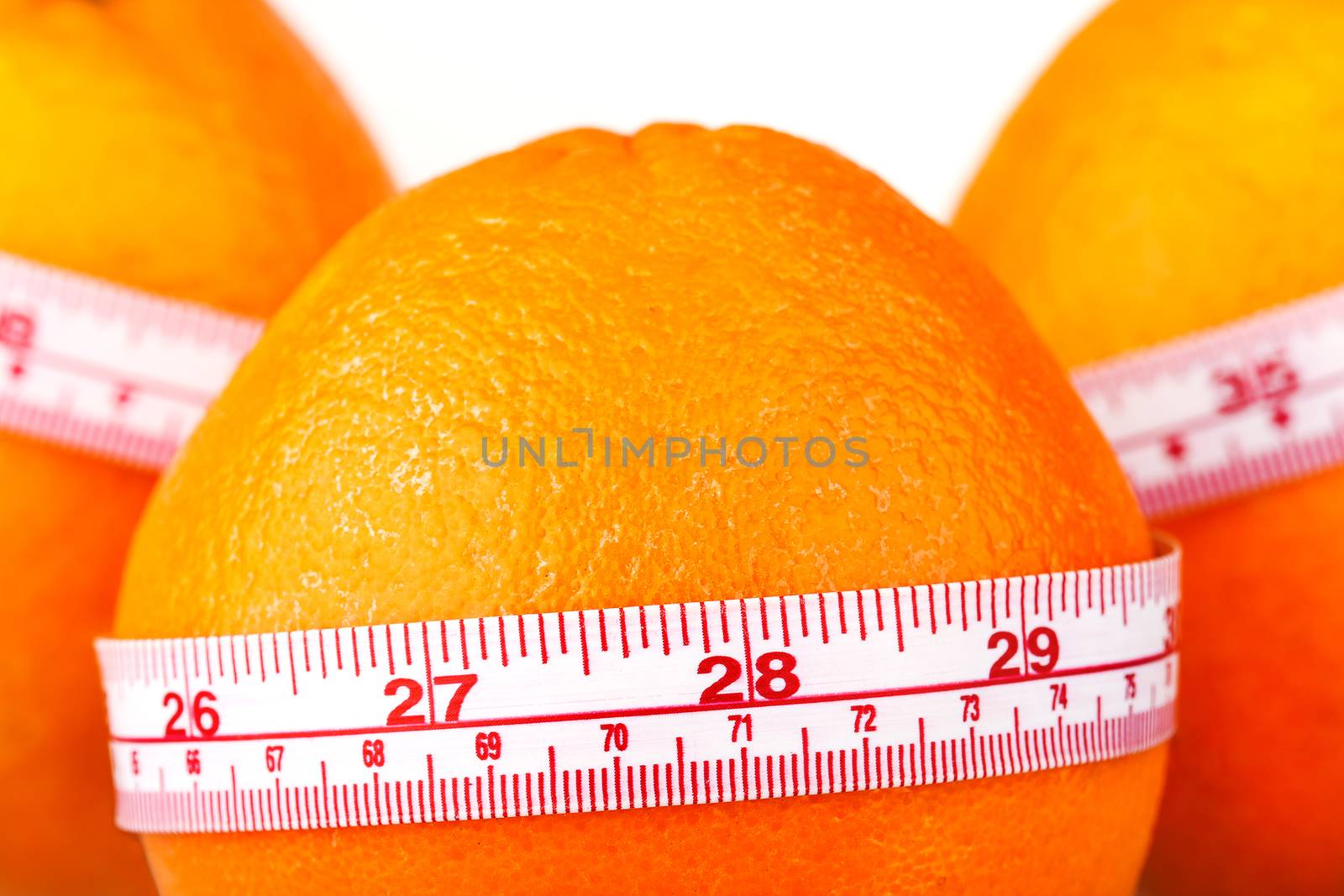 Three oranges with tailor's ruler. Orange diet. Fruit healhy vitamin diet helps to lose weight.