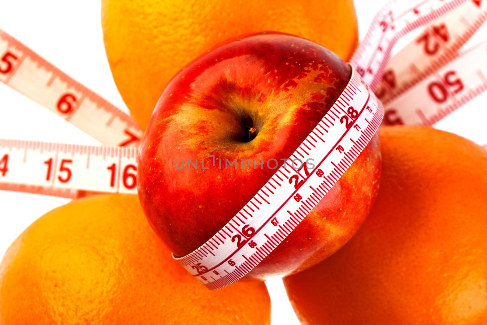 Three oranges and apple with tailor's ruler. Fruit healhy vitamin diet helps to lose weight.