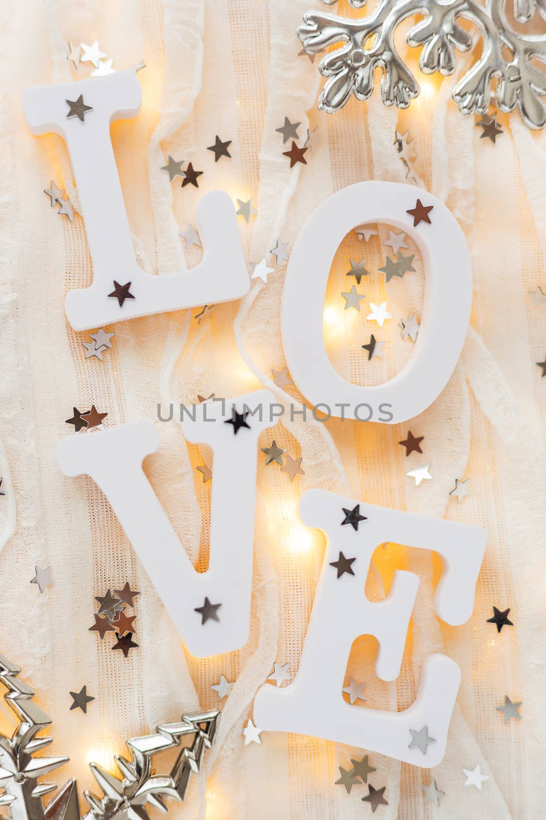 Valentine's Day background with word LOVE, decorations and light bulbs.