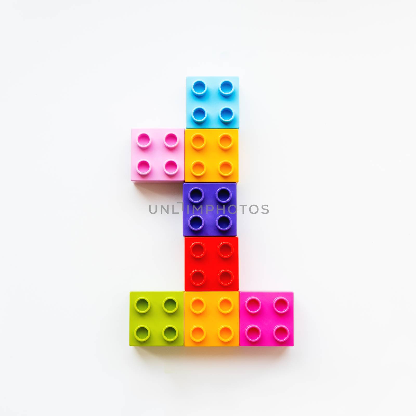 Number One made of colorful constructor blocks. Toy bricks lying in order, making number 1. Education process - learning numbers with child using multicolored toy details. by aksenovko