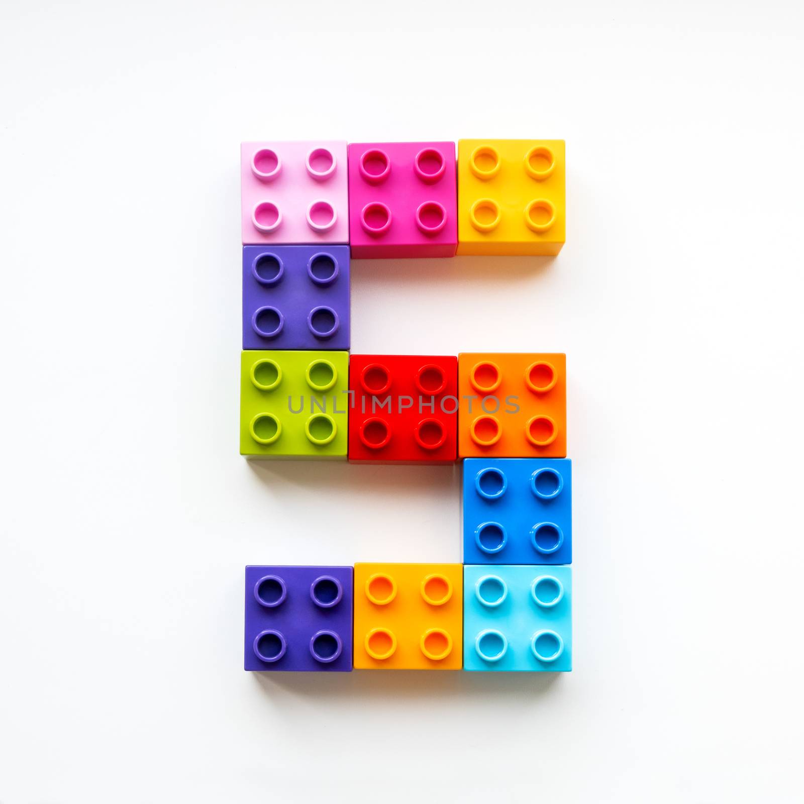 Number Five made of colorful constructor blocks. Toy bricks lying in order, making number 5. Education process - learning numbers with child using multicolored toy details. by aksenovko