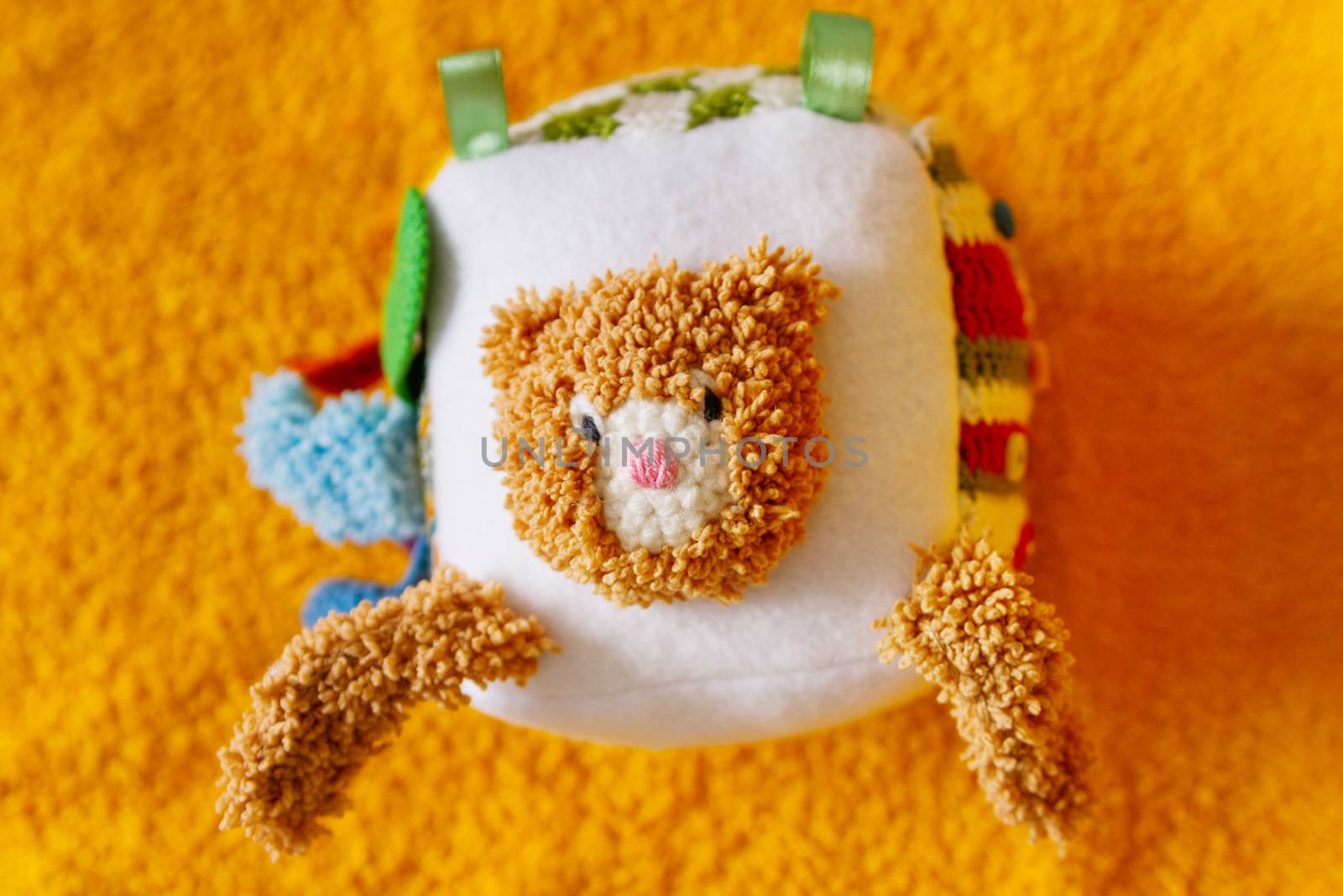 Colorful hand made toy for toddlers and babies. Busy cube. Soft baby block made of fabric to develop skills and fine motor skills. Taggie Cube. Montessori busy toy.