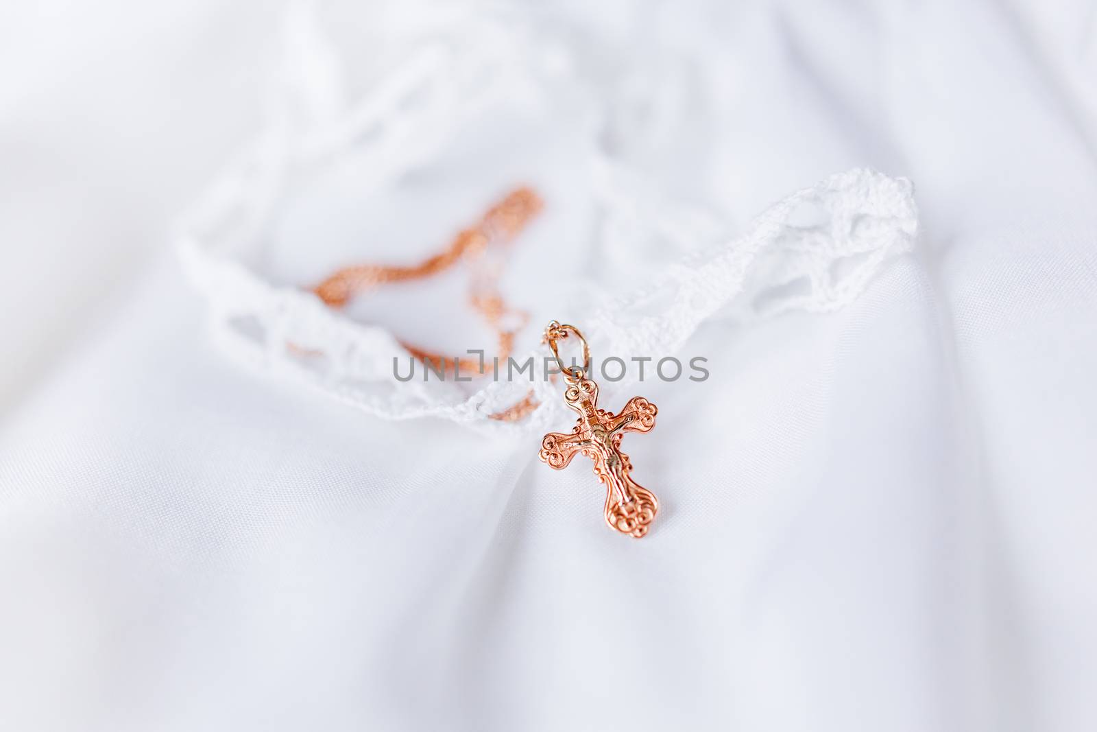 Laced dress for christening. Elegant outfit for little baby. Russian Orthodox church ceremony details.