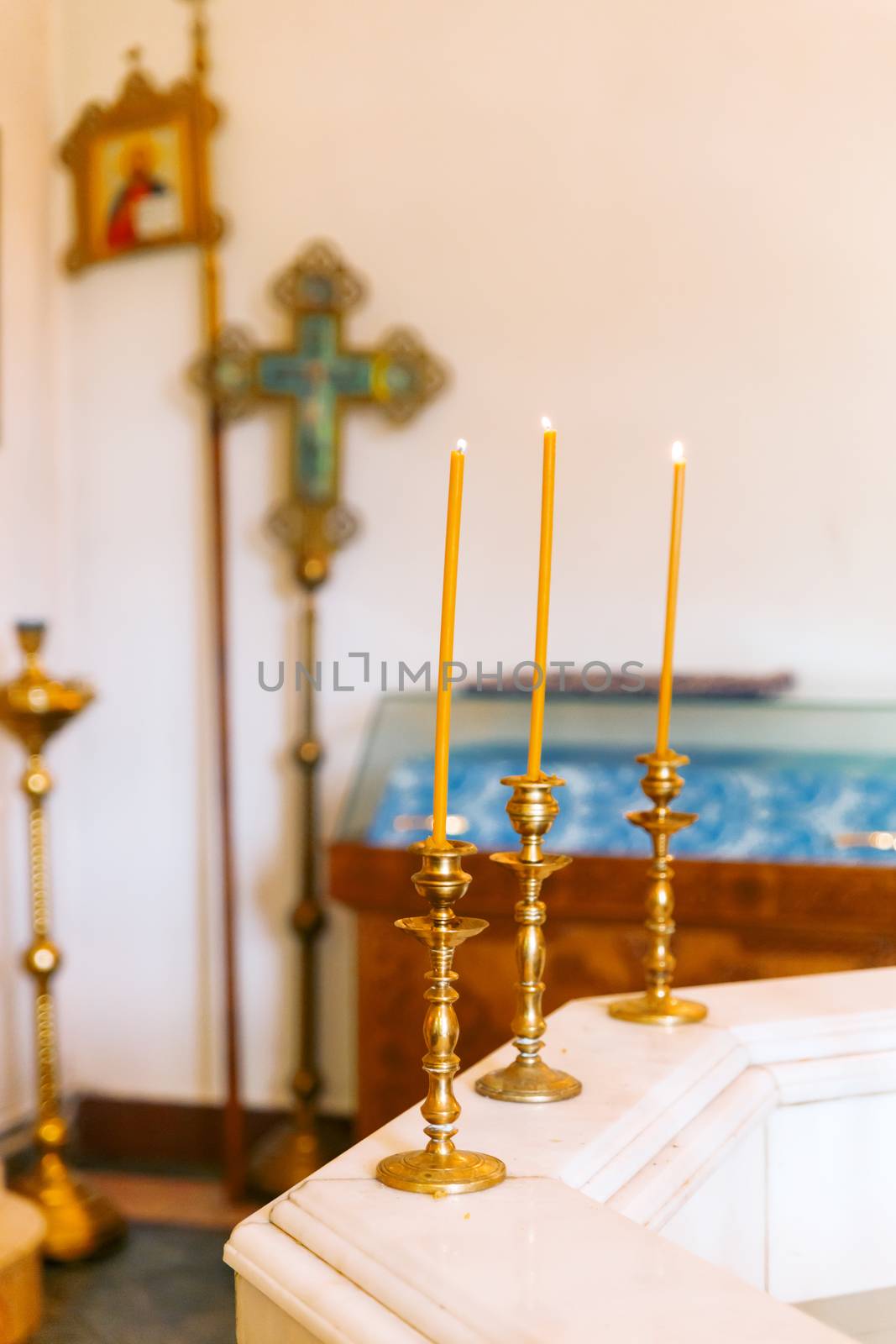 Font with candles for the christening of children in orthodox church. Russia.