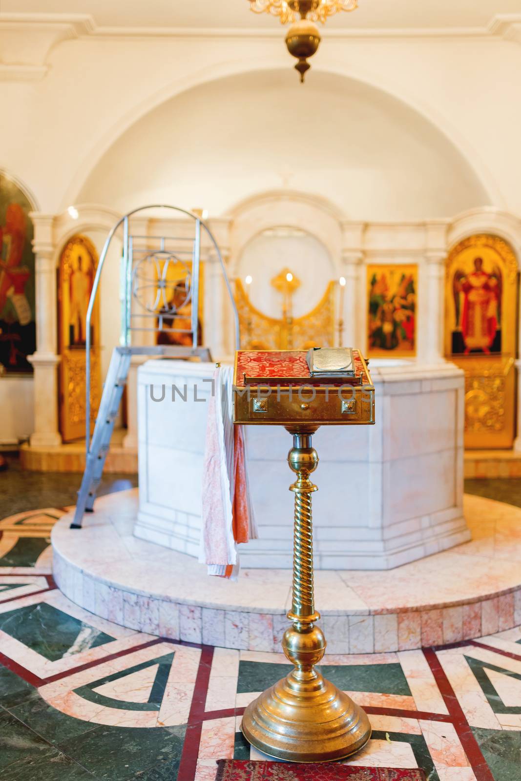 Golden religious utensils - Bible, cross, prayer book, missal, baptismal font. Details in the Orthodox Christian Church. Russia.