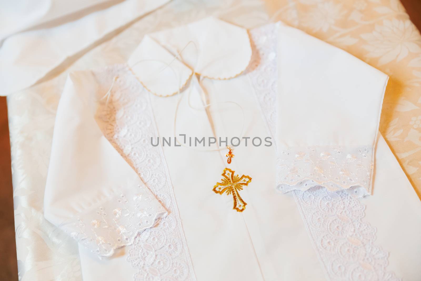 Laced dress for christening. Elegant outfit for little baby. Russian Orthodox church ceremony details.