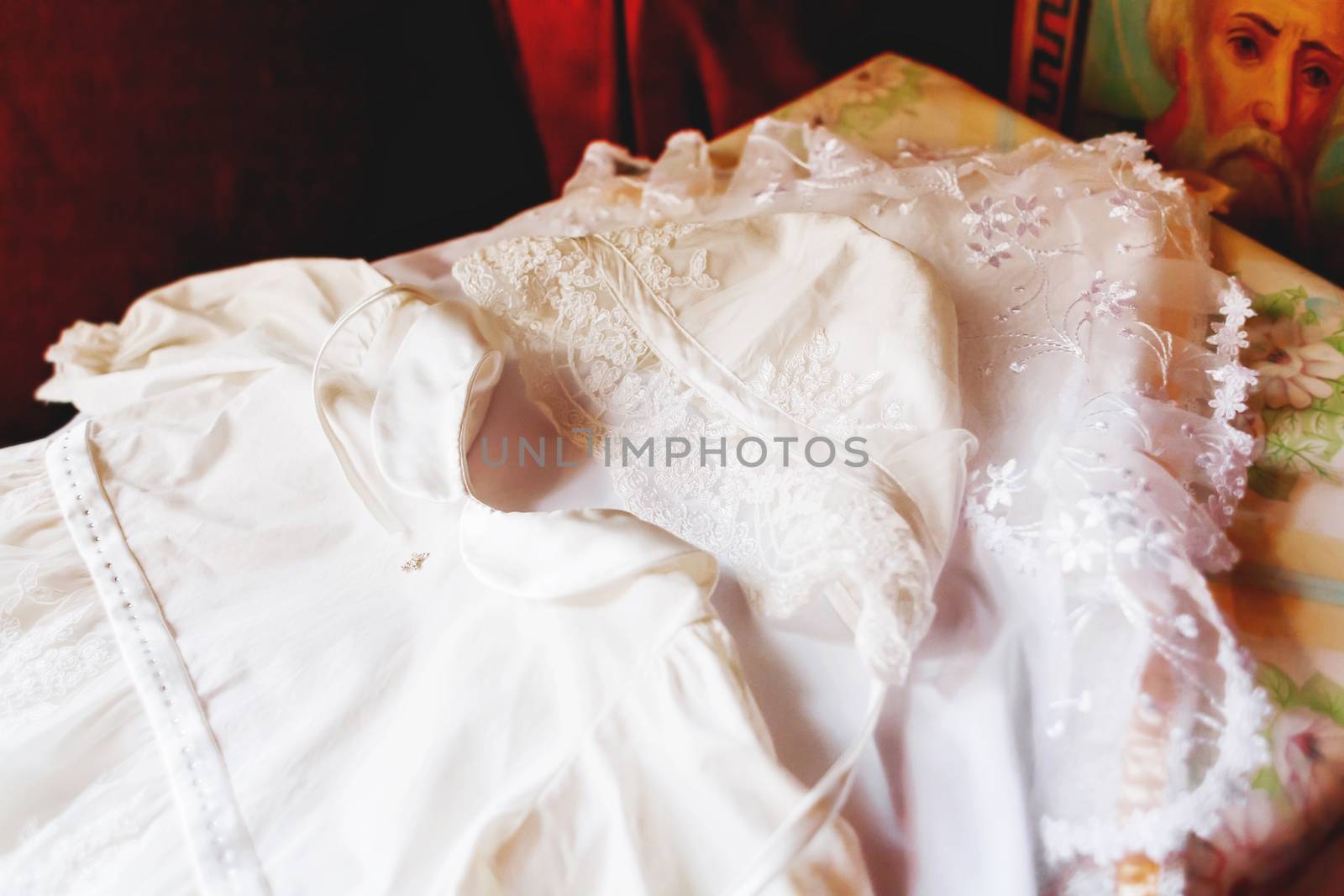 Laced dress for christening. Elegant outfit for little girl. Russian Orthodox church ceremony details.