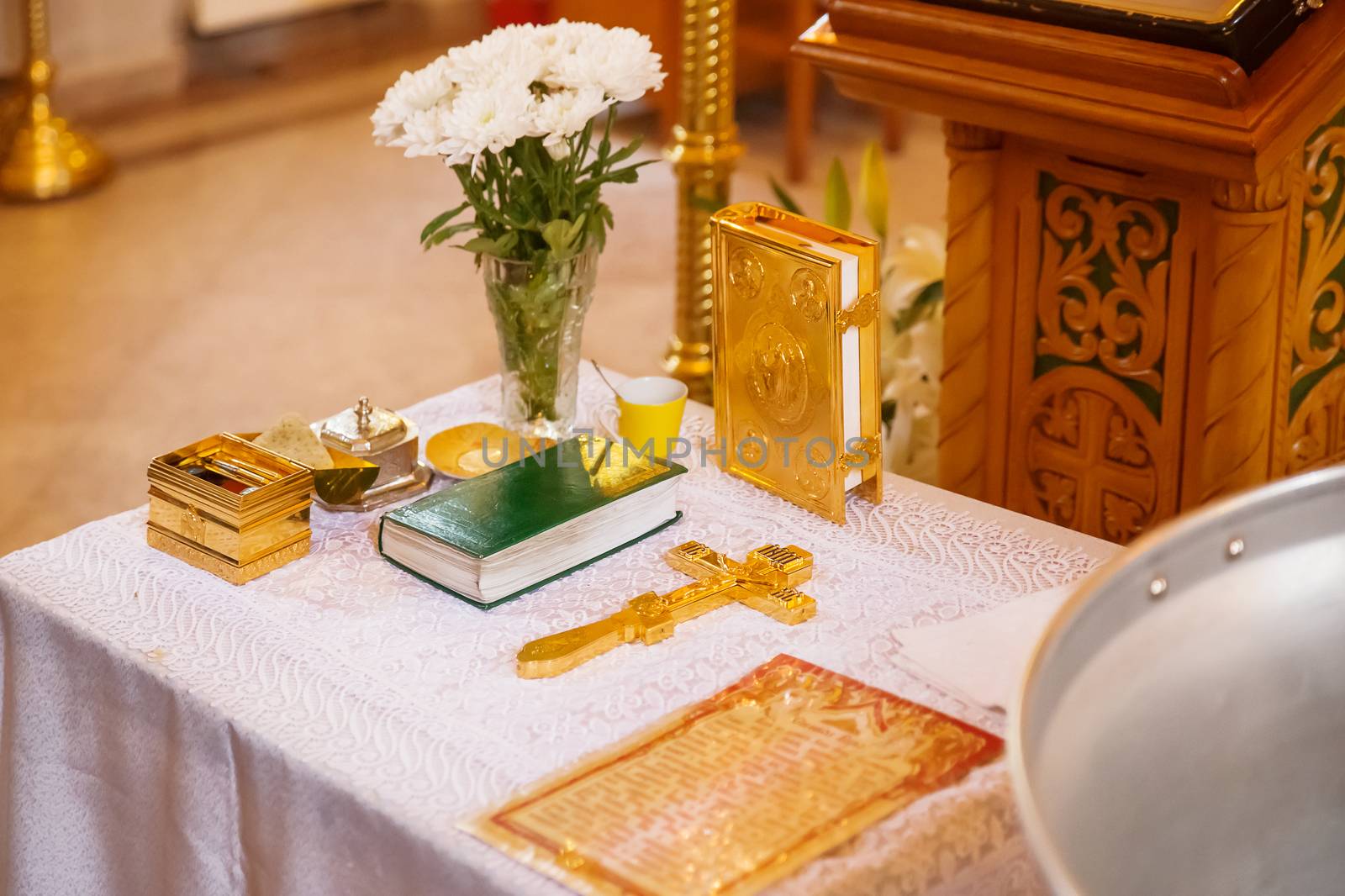 Golden religious utensils - Bible, cross, prayer book, missal. Details in the Orthodox Christian Church. Russia.