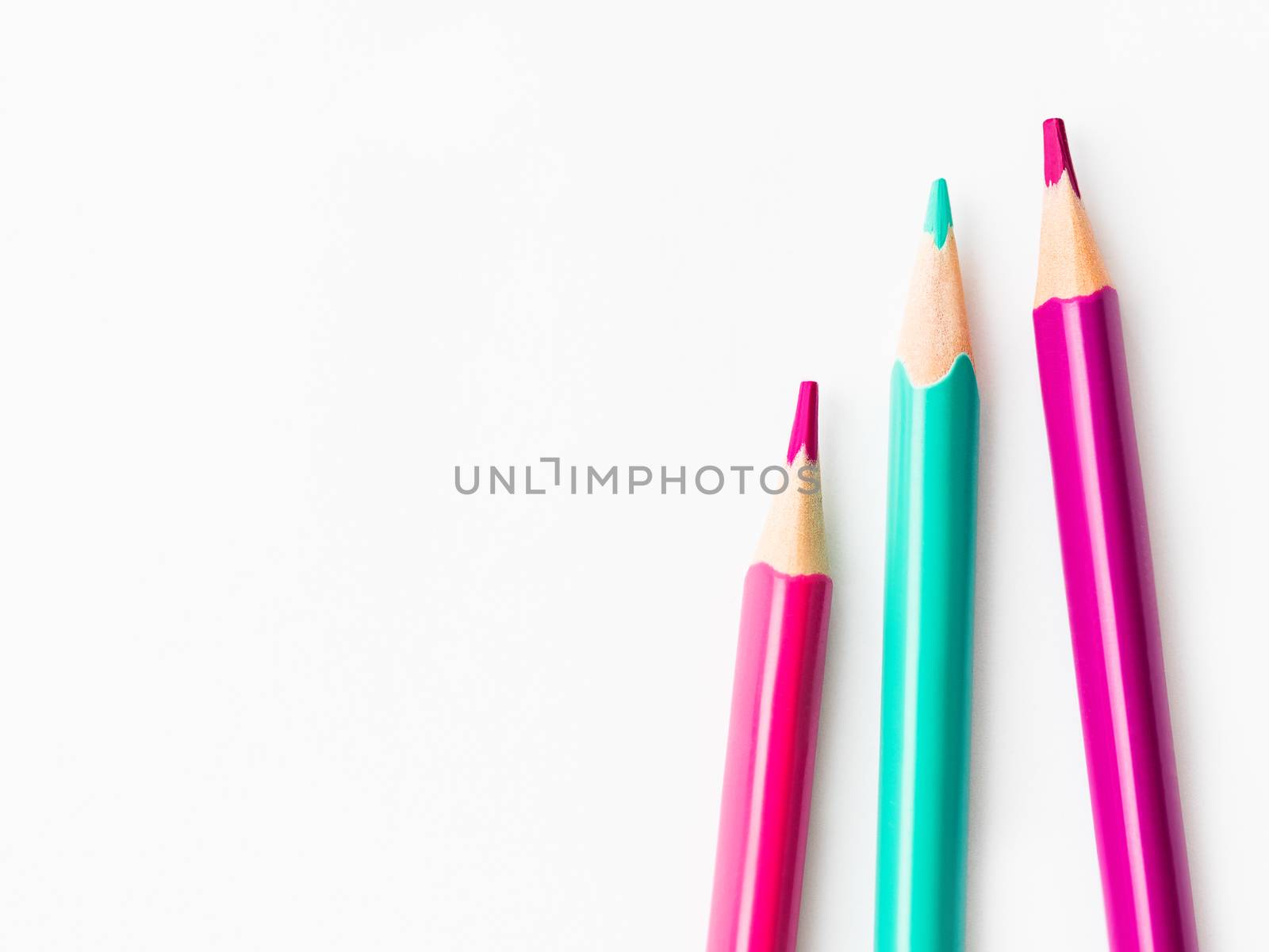 Colorful watercolor pencils on white background. School supplies with copy space. Kid's stationery. Back to school backdrop.