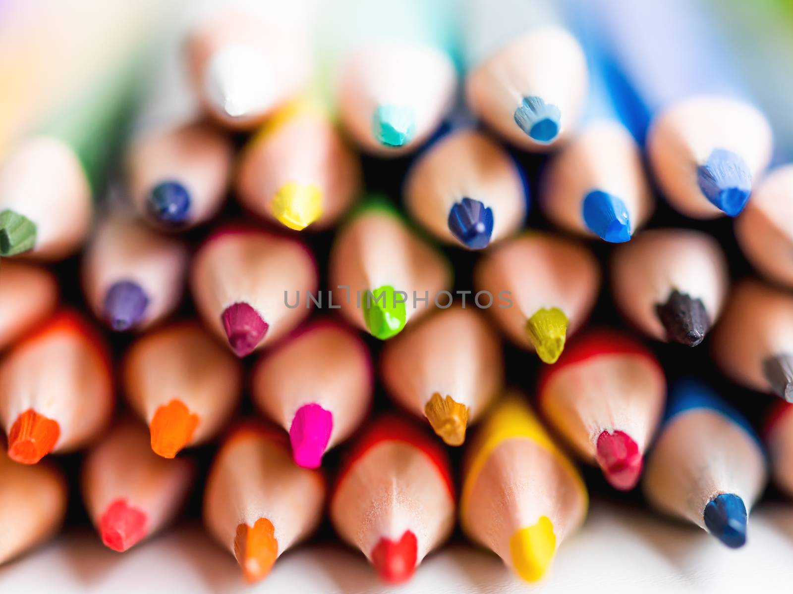 Cores of colorful watercolor pencils. School supplies background. Kid's stationery. Back to school macro backdrop.