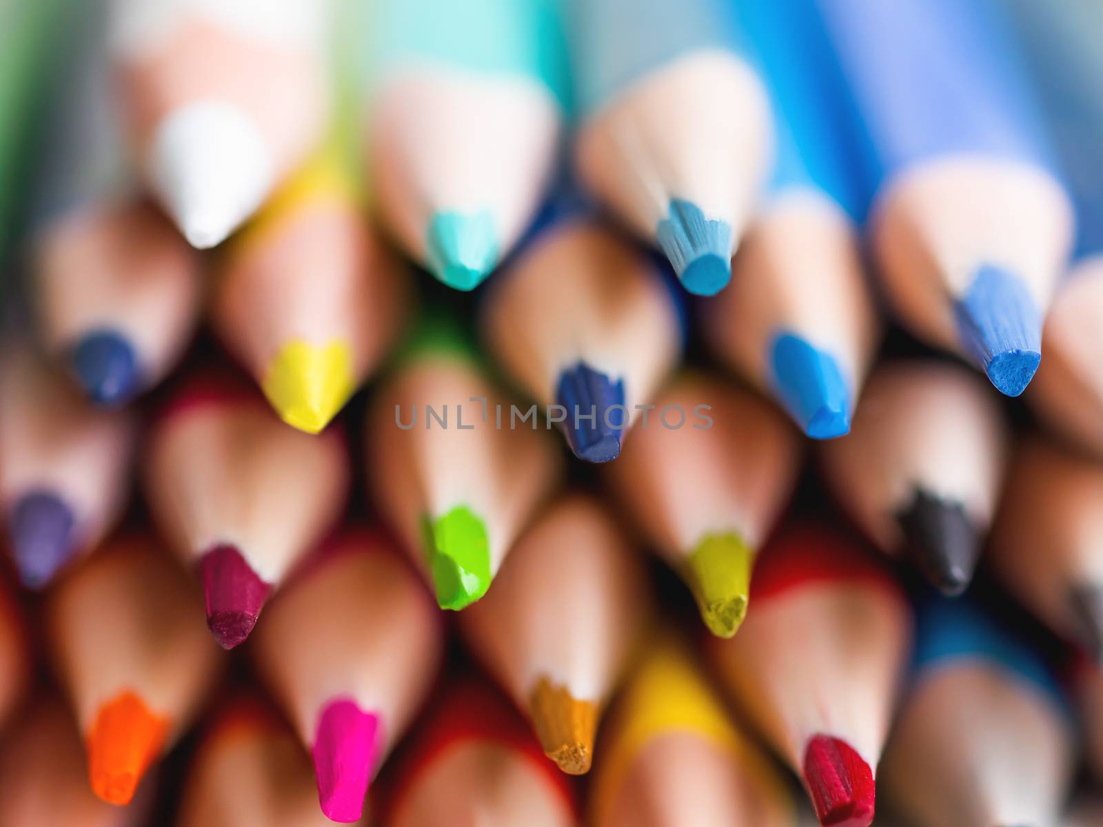 Cores of colorful watercolor pencils. School supplies background. Kid's stationery. Back to school macro backdrop.