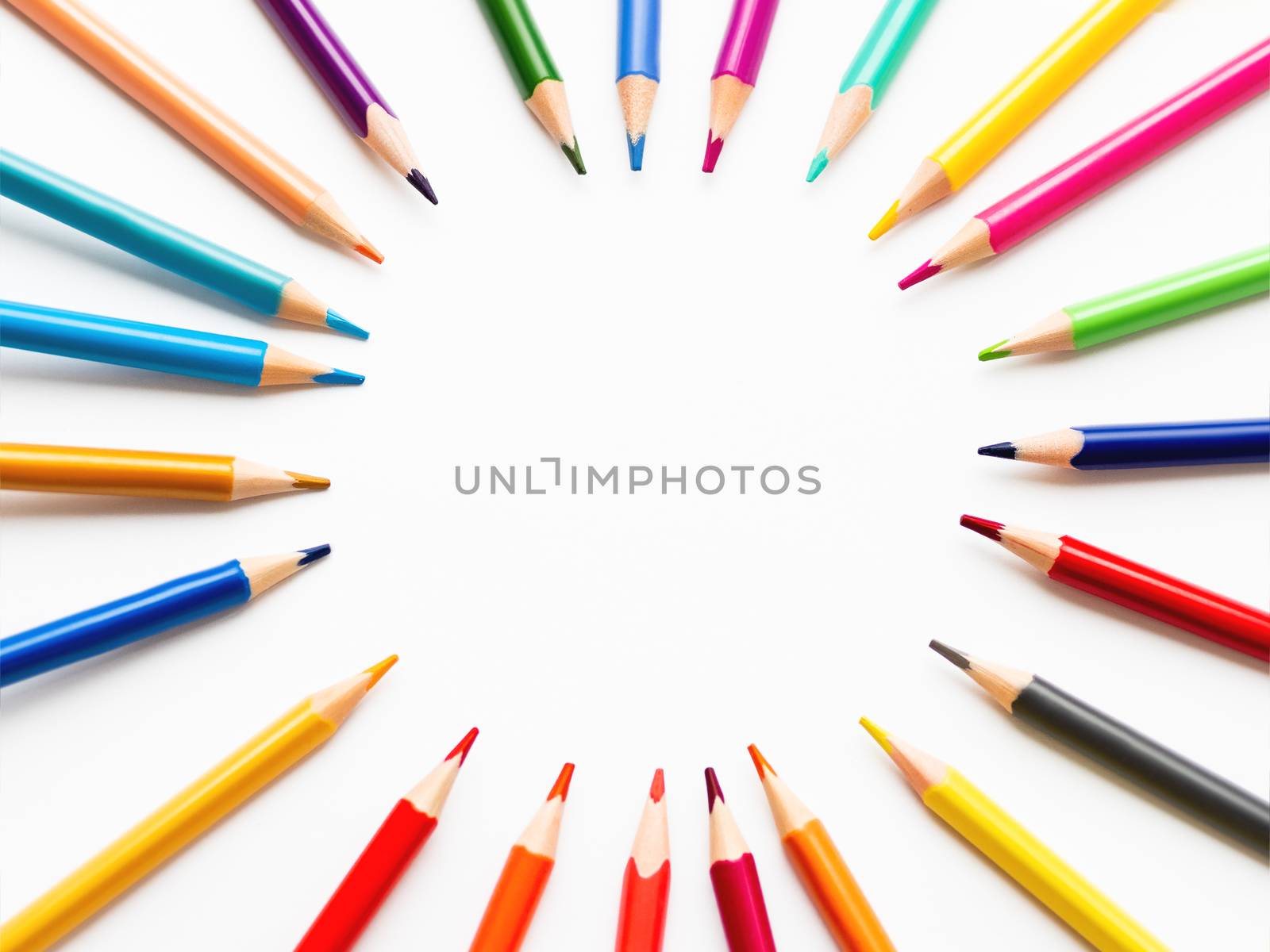 Colorful watercolor pencils on white background. School supplies with round copy space. Kid's stationery. Back to school circle backdrop.