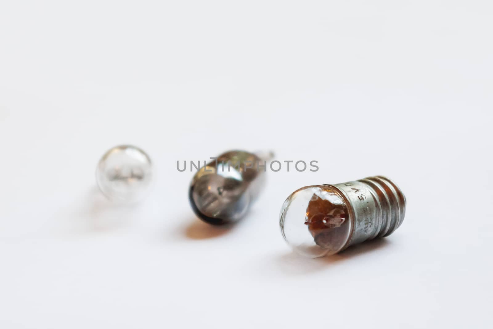 Small old light bulbs. Three incandescent lamps on white background.
