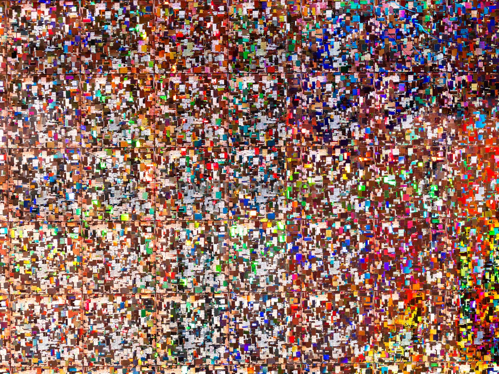 Bright rainbow colored background. Shiny and sparkling holographic backdrop. Top view, flat lay.