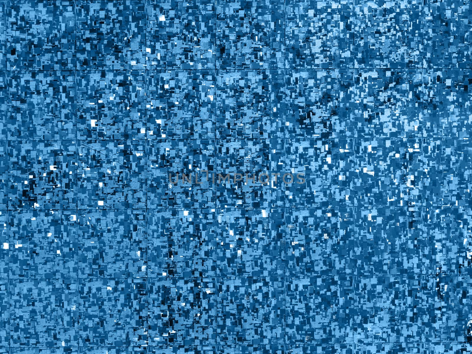 Bright classic blue background. Shiny and sparkling holographic blue backdrop. Top view, flat lay.