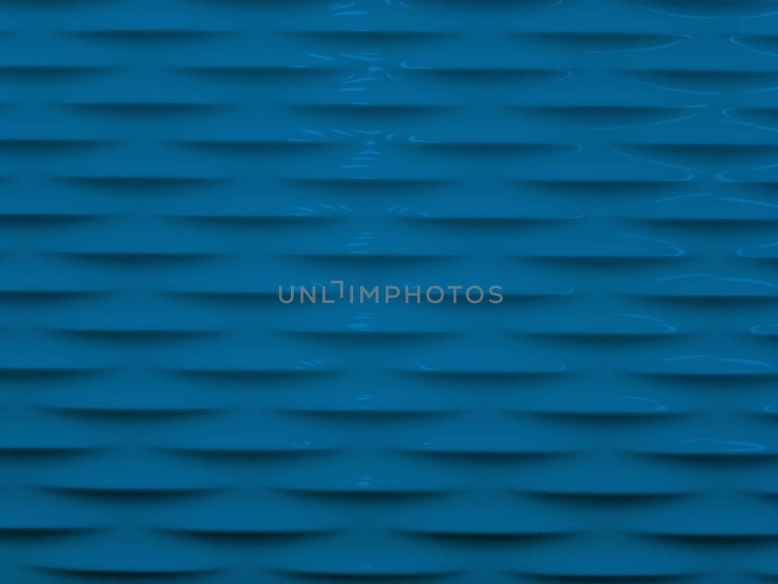 Abstract background of blue smooth and sleek wall with embossed pattern.