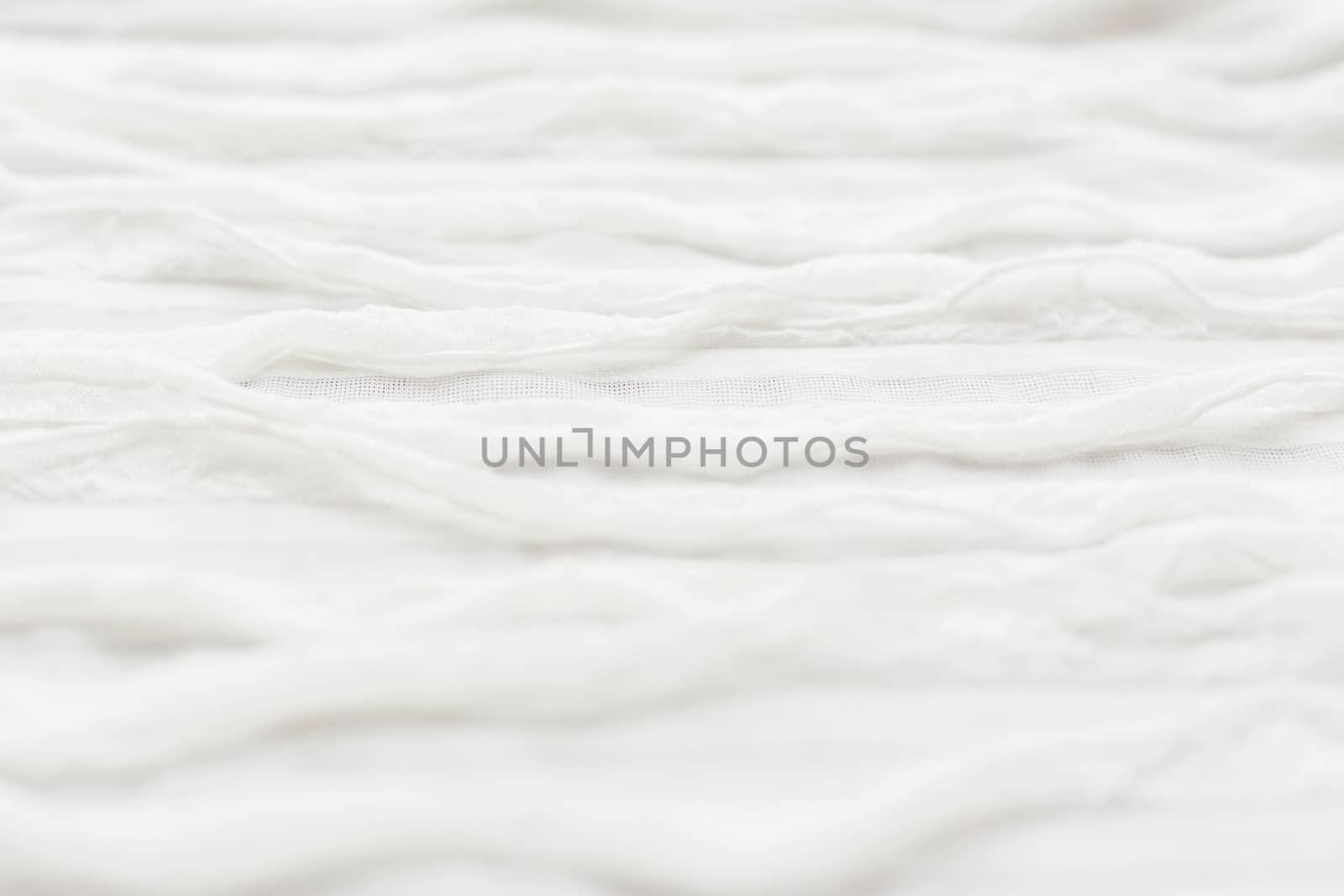 Abstract textile background. White fabric with ruche.