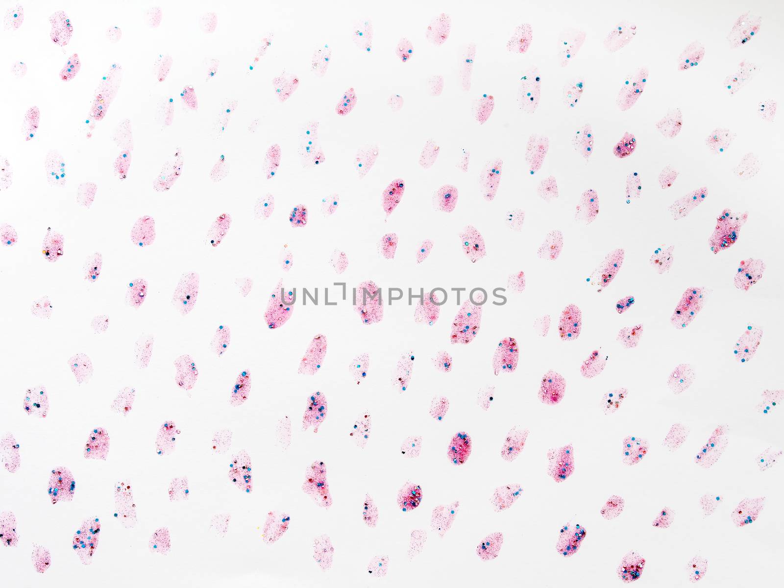 Abstract background with glitter stains with shiny sparkling rhinestones. Pink backdrop.
