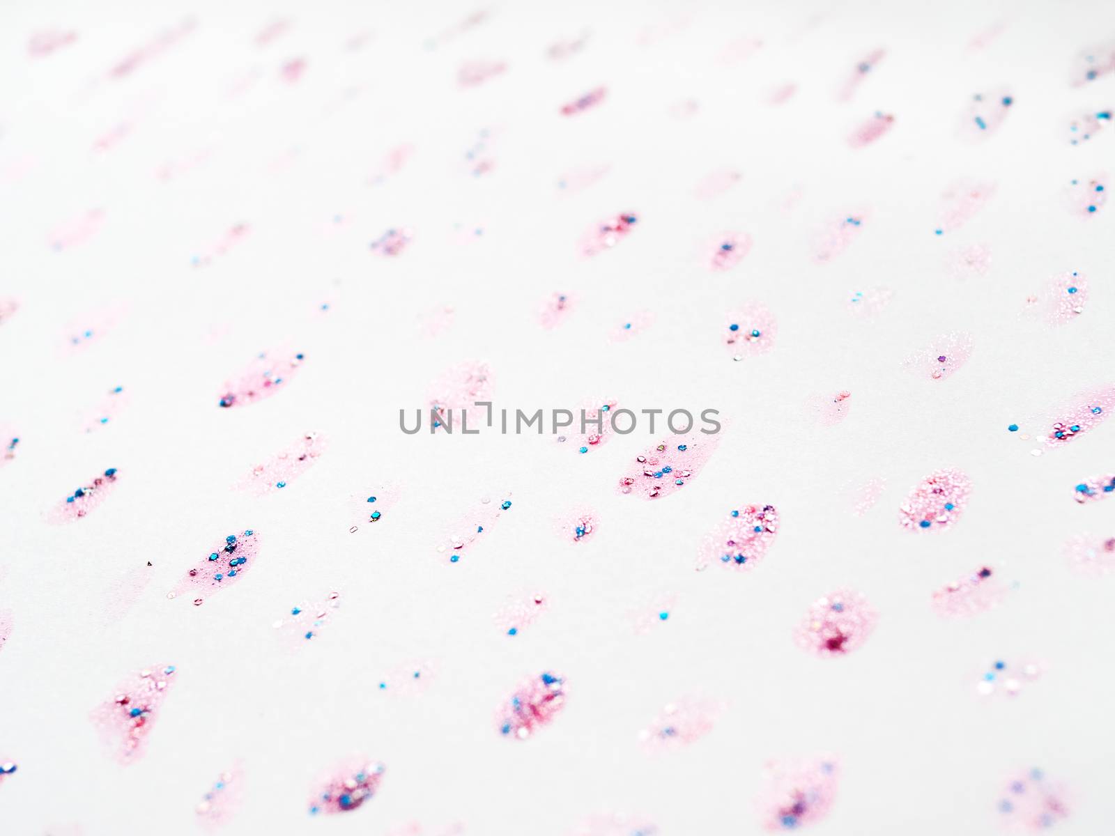 Abstract background with glitter stains with shiny sparkling rhinestones. Pink backdrop.