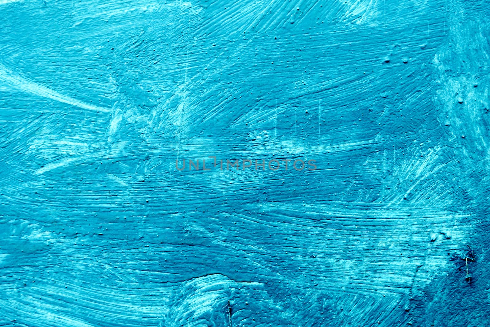 Abstract background with textured strokes of blue paint on the wooden surface.