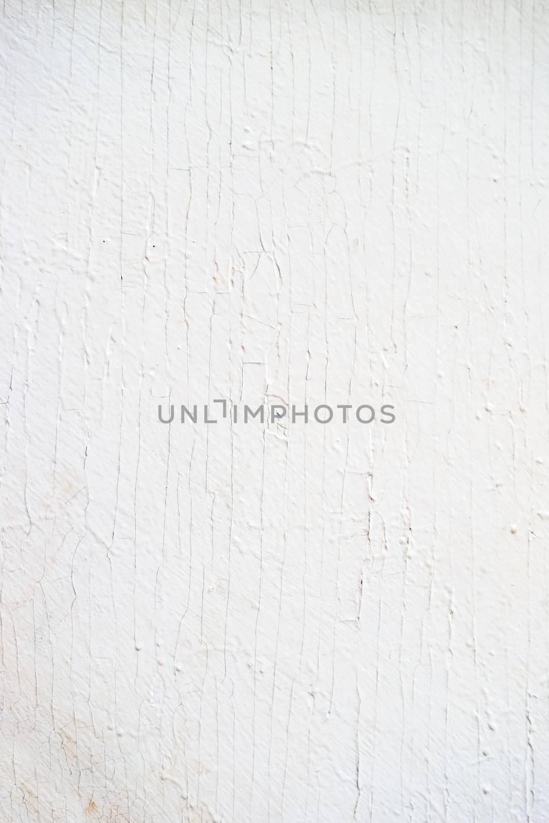Wooden background of old fence with rusty nails. Shabby texture of white colored wooden boards.