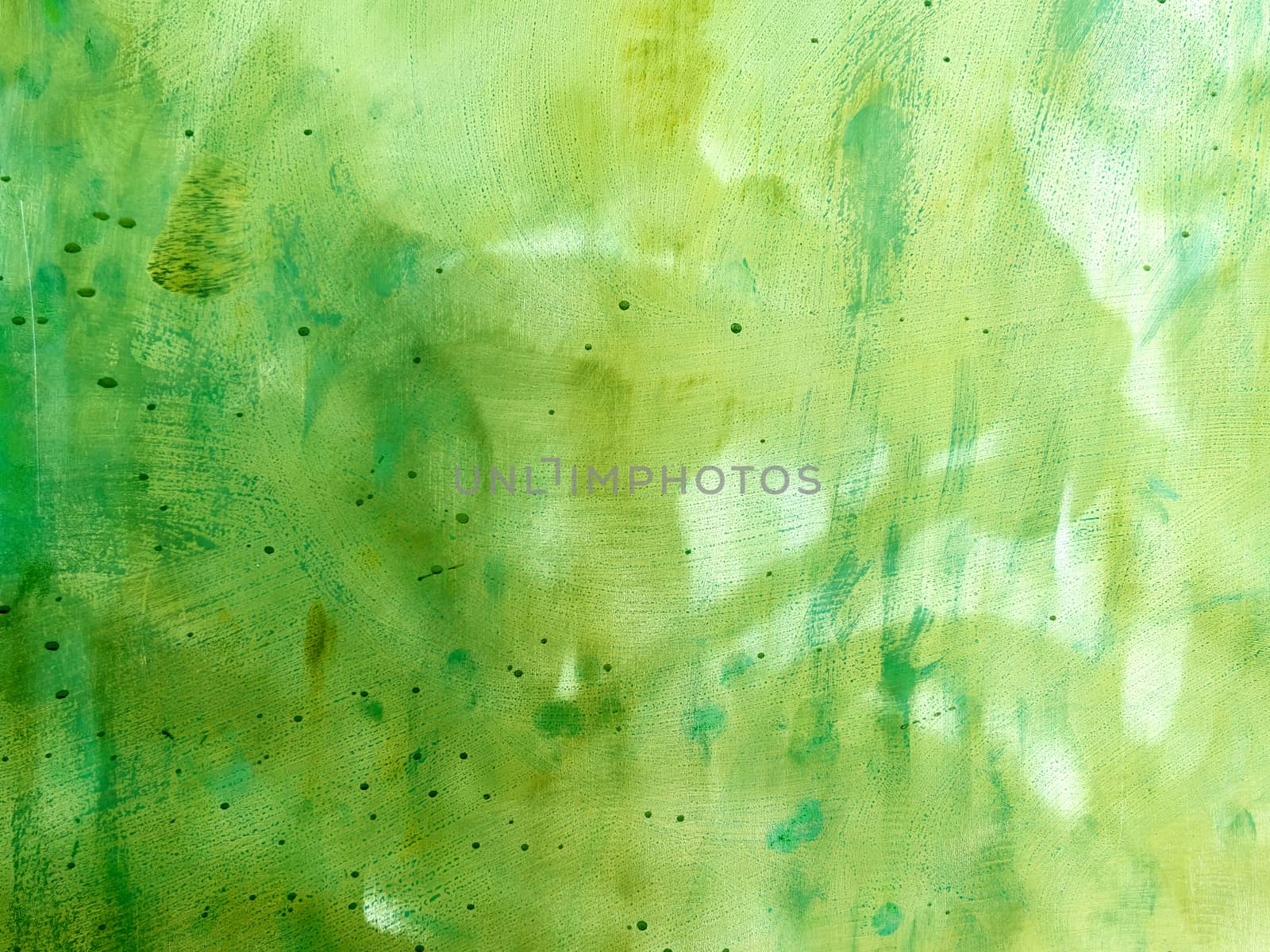 Green abstract metal background with scratches and stains. Colorful backdrop with blots and strokes.