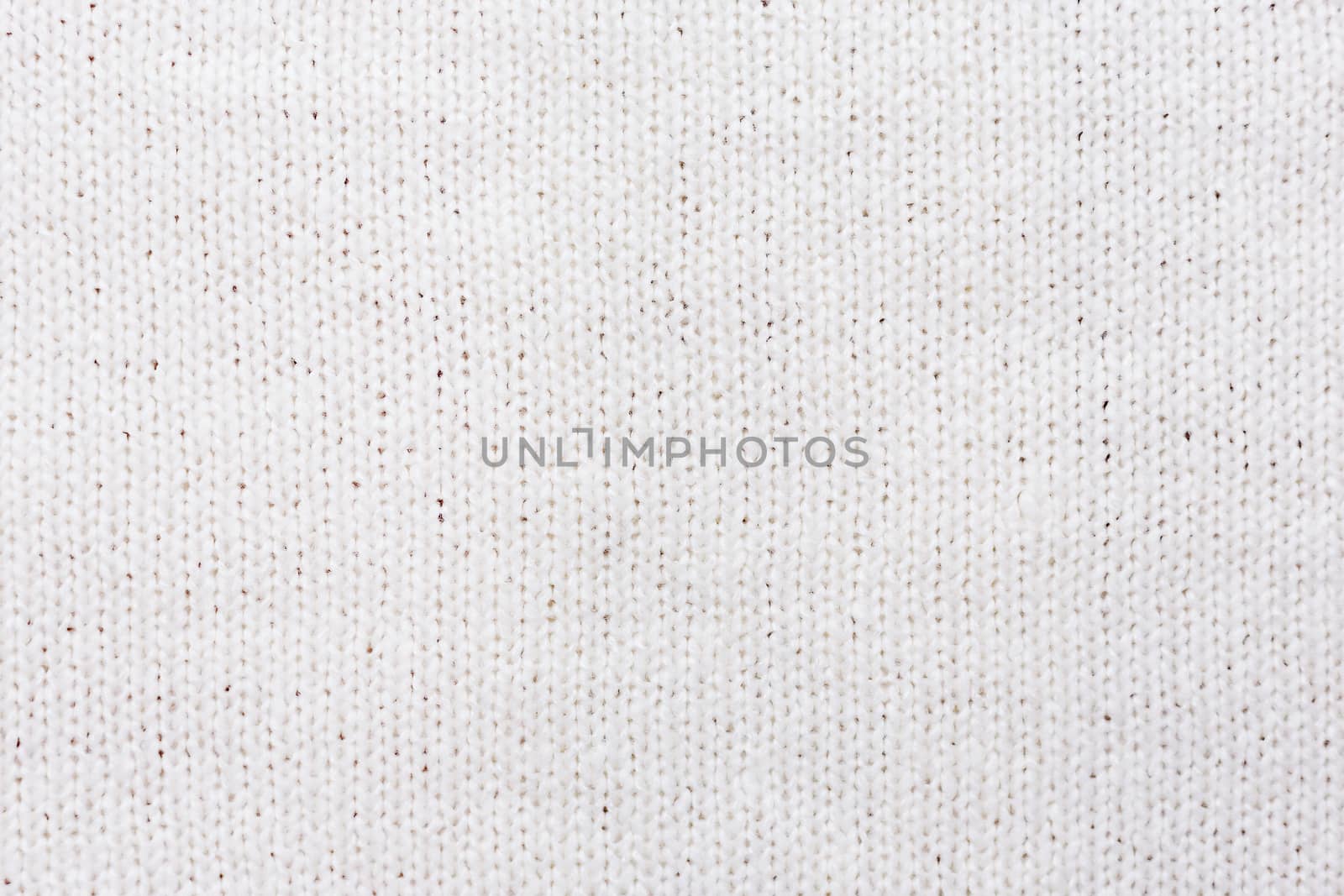 Abstract knitted background. Wool white sweater texture. Close up picture of knitted pattern.