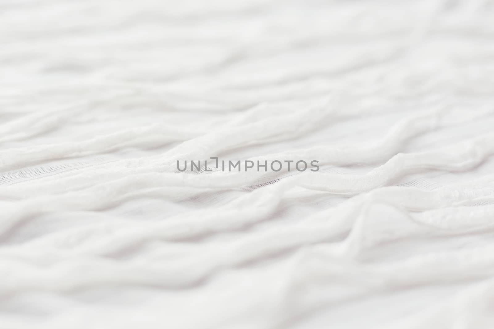 Abstract textile background. White fabric with ruche.