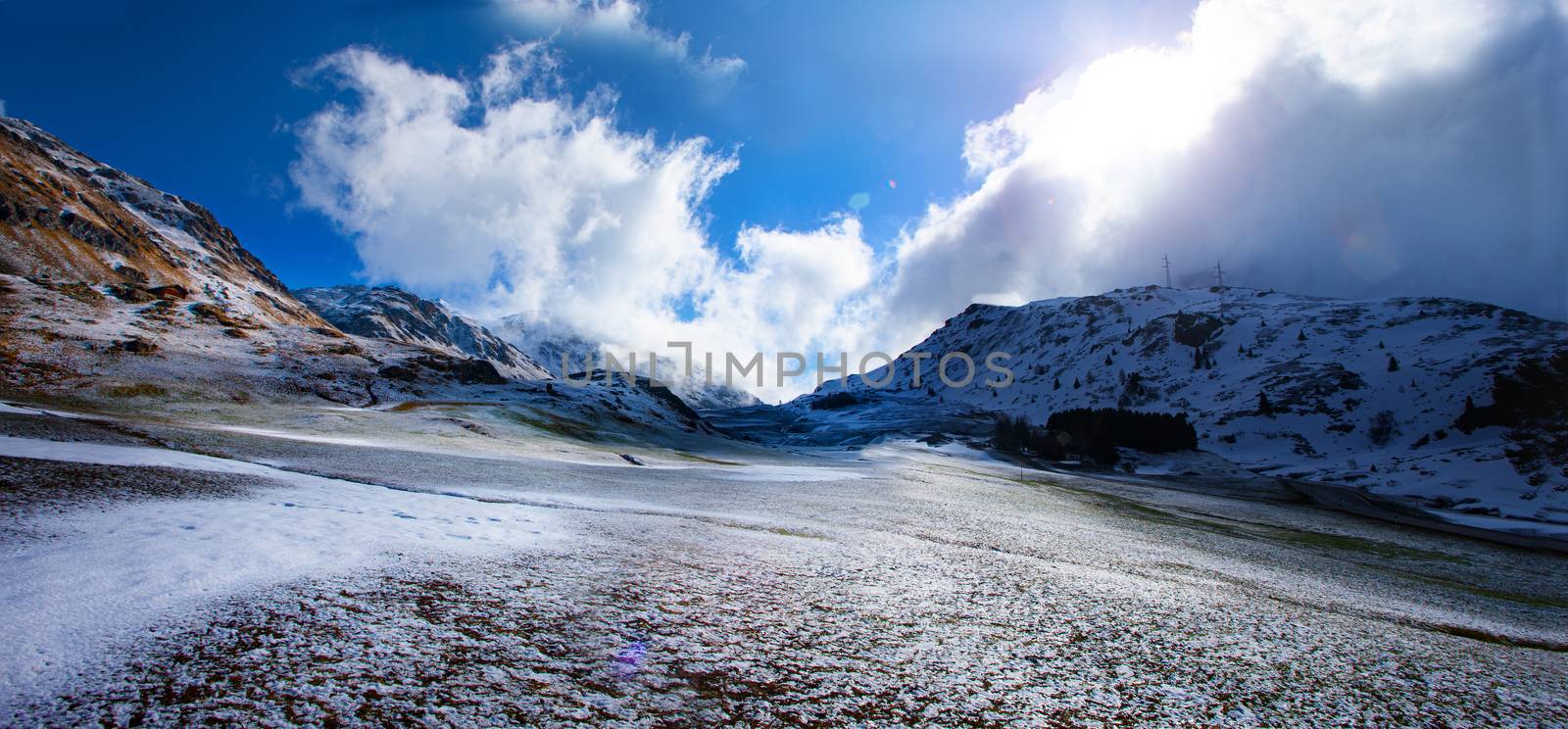 Alpine pass in switzerland, Julierpass in swiss alp with snow and cloudy sky