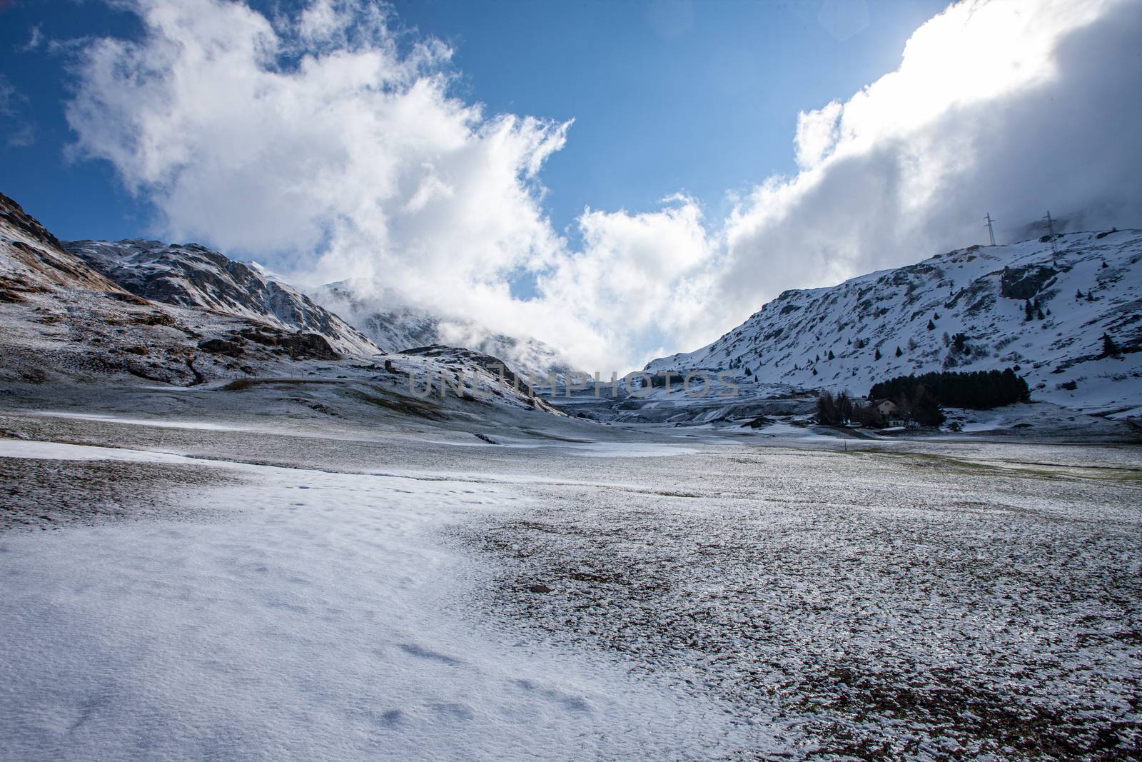 Alpine pass in switzerland, Julierpass in swiss alp with snow and cloudy sky