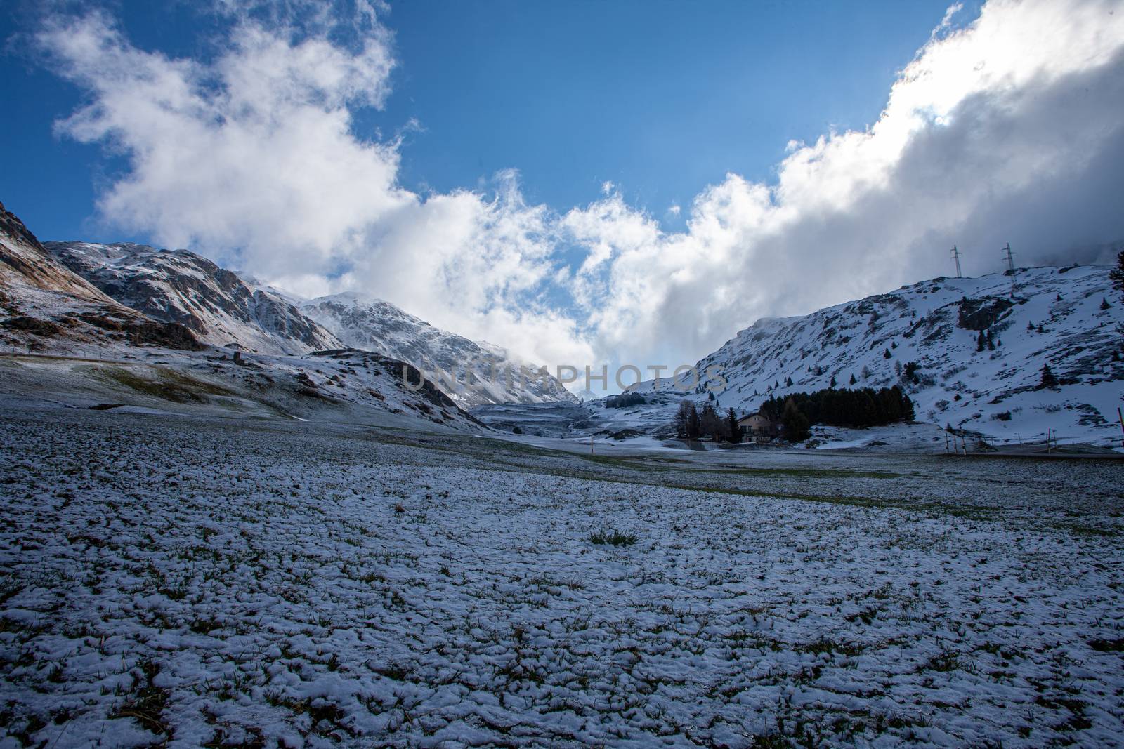 Alpine pass in switzerland, Julierpass in swiss alp with snow and cloudy sky