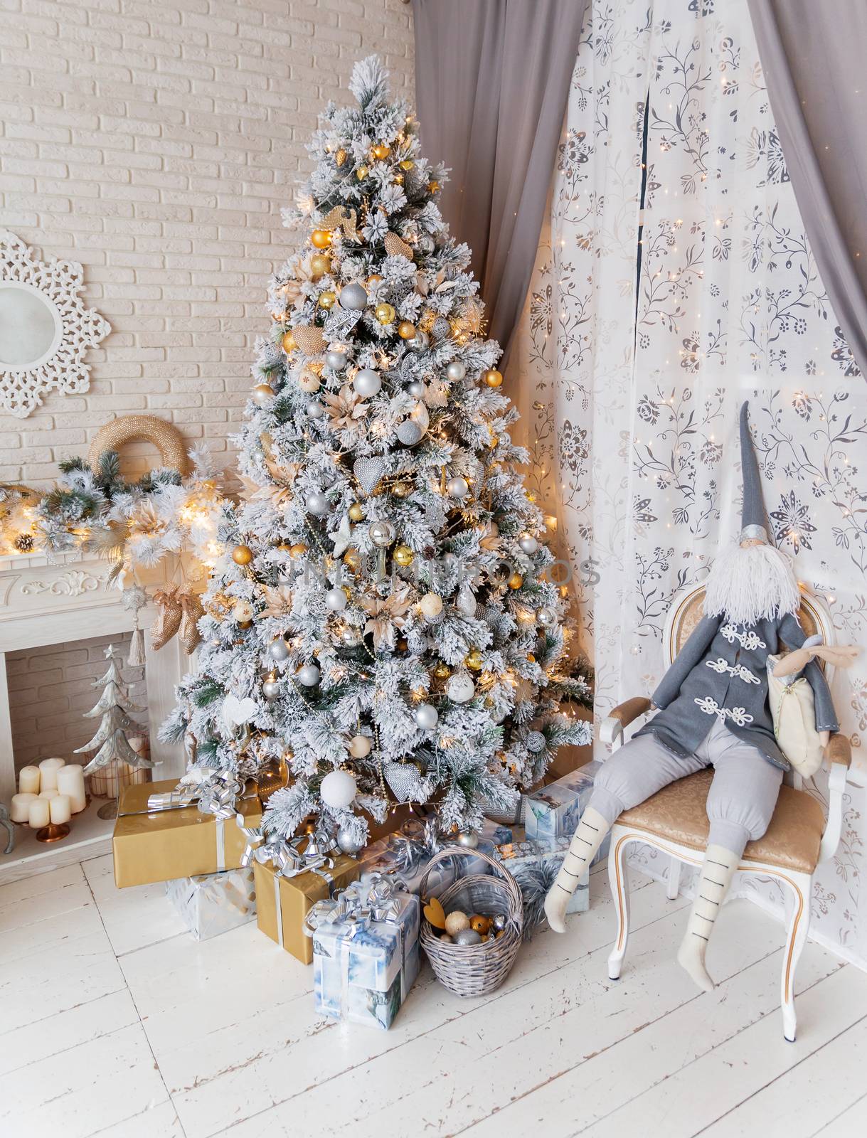 Christmas and New Year Eve Tree. Holiday winter background. Interior details - mirror-snowflake, mantelpiece with garland of light bulbs, many presents and elf with gifts.