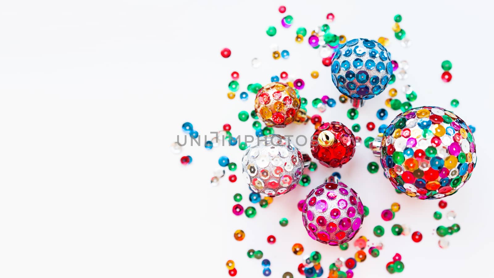 Christmas and New Year background with decorations - bright balls, hand made with colorful sparkling spangles. Place for text.