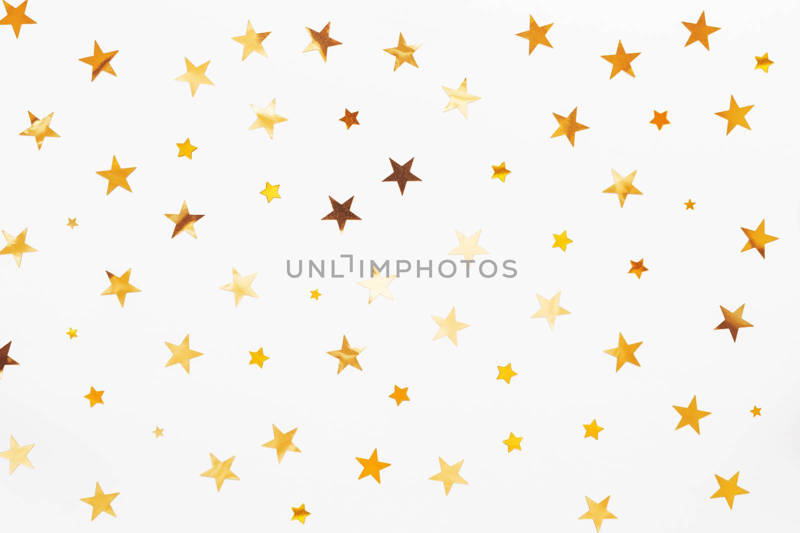 Holiday background with golden star confetti. Good background for Christmas and New Year cards.
