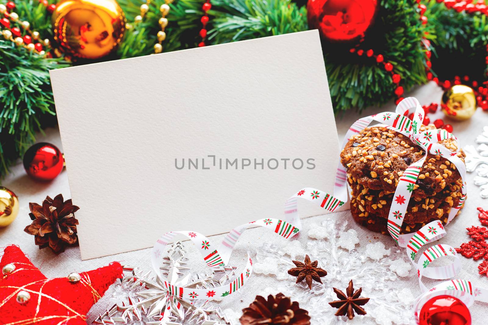 Christmas and New Year background with decorations, cookies, pine cones and clear paper for your text. Mock up.