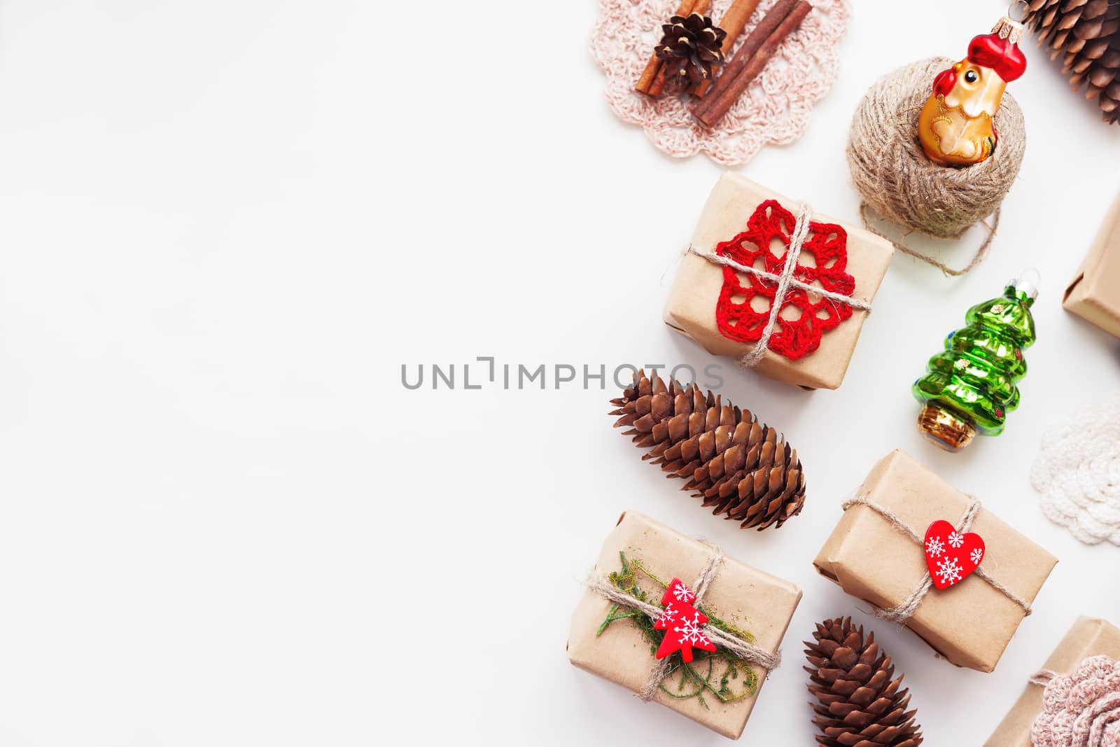 Christmas and New Year background with handmade presents wrapped in craft paper and decorations, holiday symbols. Place for text.