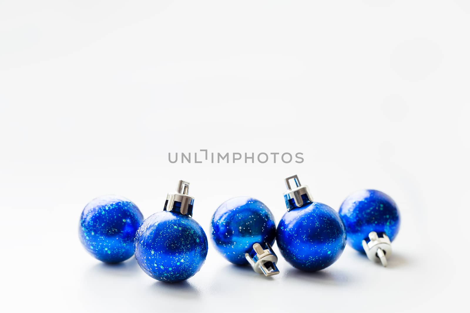 Christmas and New Year background with blue starry decorative balls for Christmas tree. Place for text.