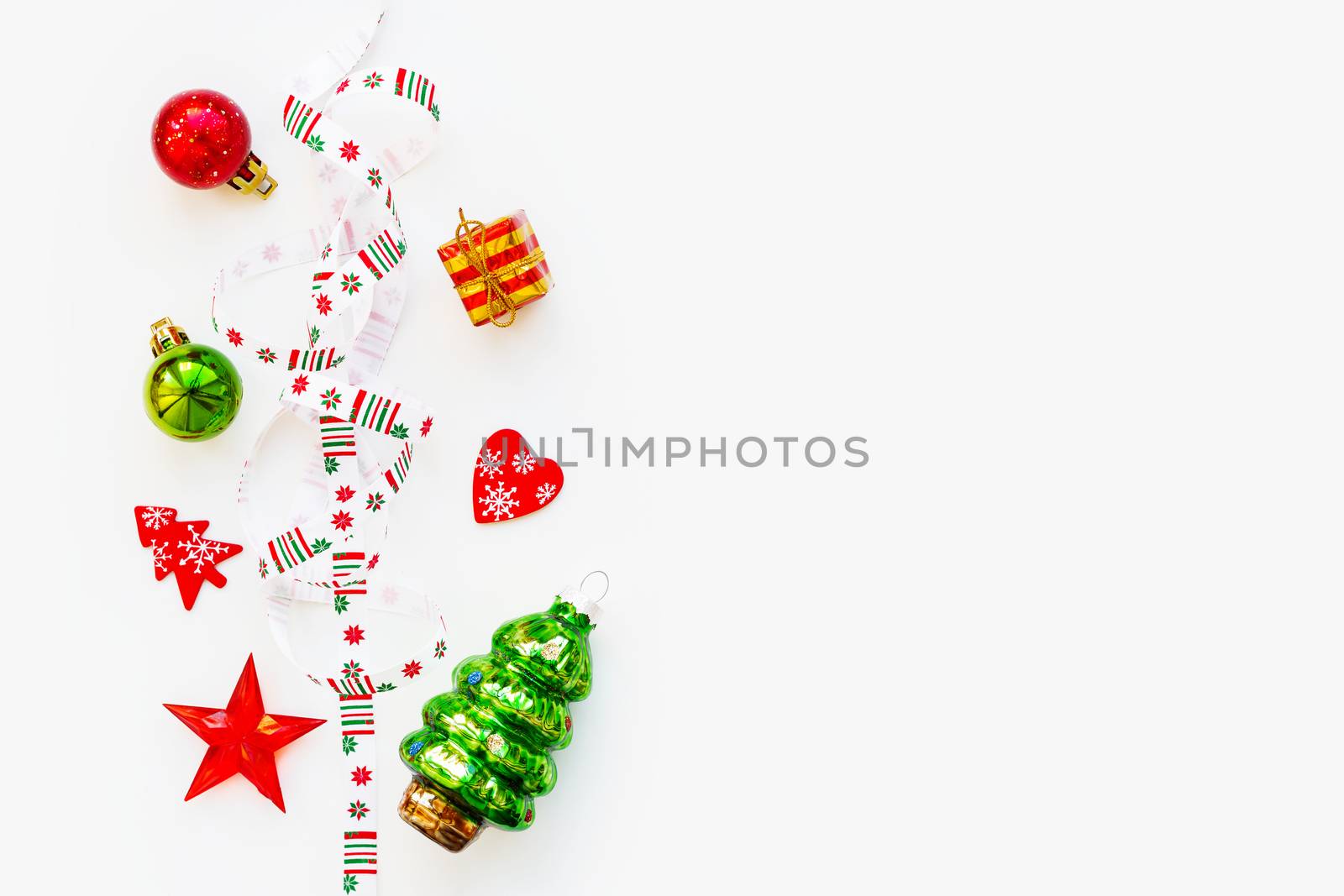 Ribbon with Christmas pattern - nordic geometric snowflakes. New Year decorations - bright colorful balls, fir tree, star. Place for text. Flat lay, top view.