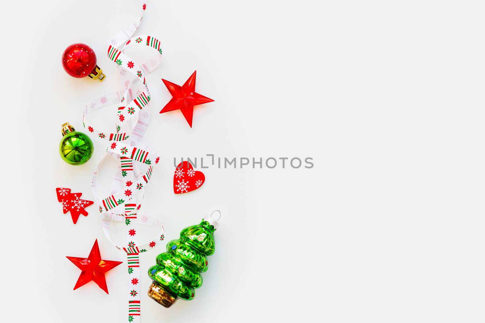 Ribbon with Christmas pattern - nordic geometric snowflakes. New Year decorations - bright colorful balls, fir tree, star. Place for text. Flat lay, top view.