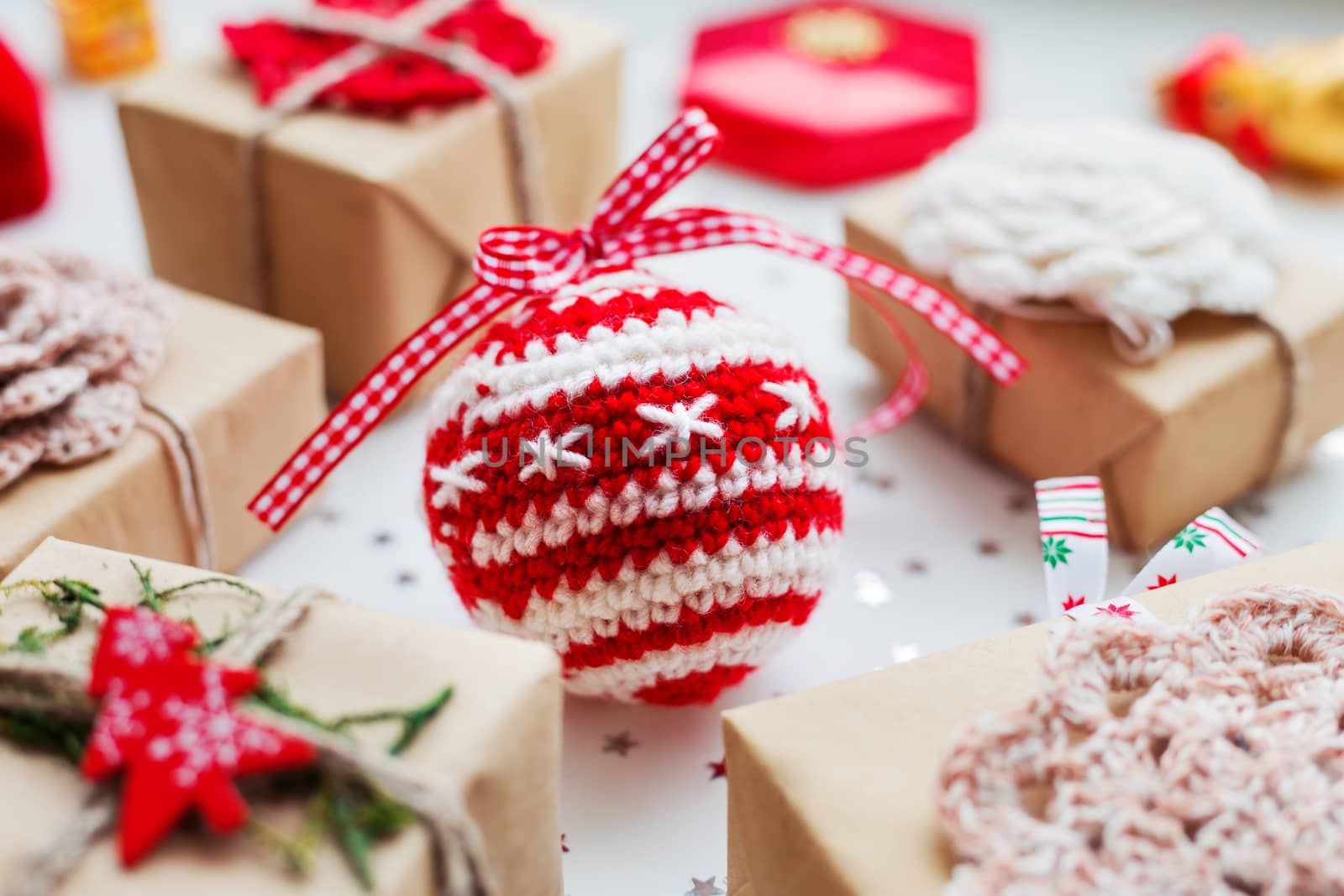 Christmas and New Year background with presents, decorations and crocheted handmade decorative ball.