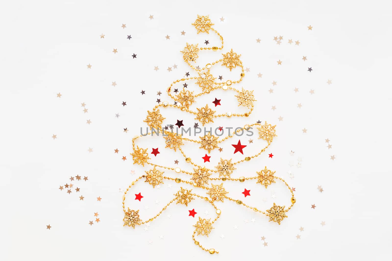Christmas Tree made of golden snowflake garland with silver star confetti. New Year symbol with place for text. Flat lay, top view.
