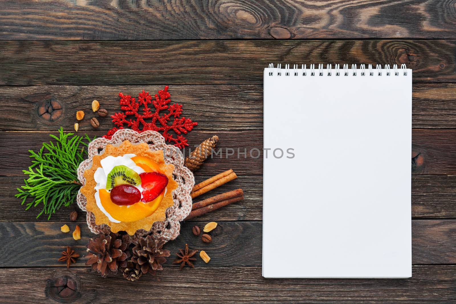 Christmas and New Year 2017 background with fruit tart and decorations - snowflake, crochet napkin, pine cones. Place for text.