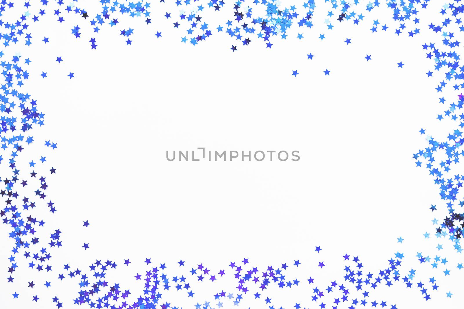 Holiday background with frame of blue star confetti. Good background for Christmas and New Year cards.