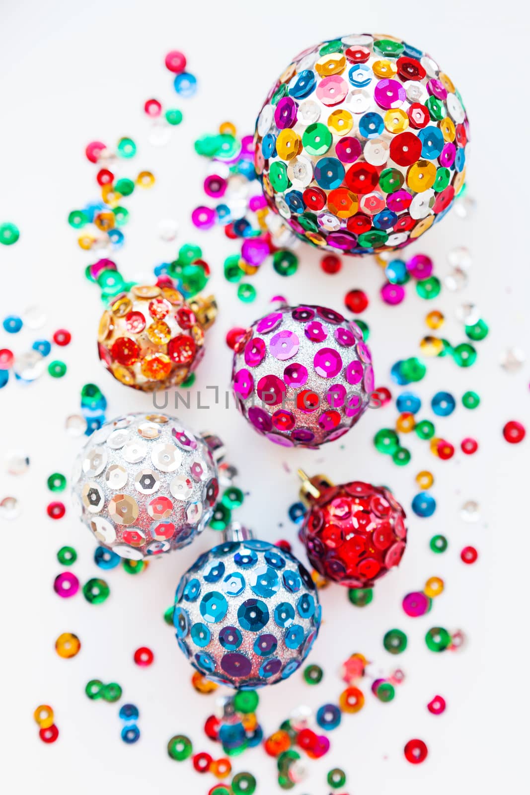 Christmas and New Year background with decorations - bright balls, hand made with colorful sparkling spangles.