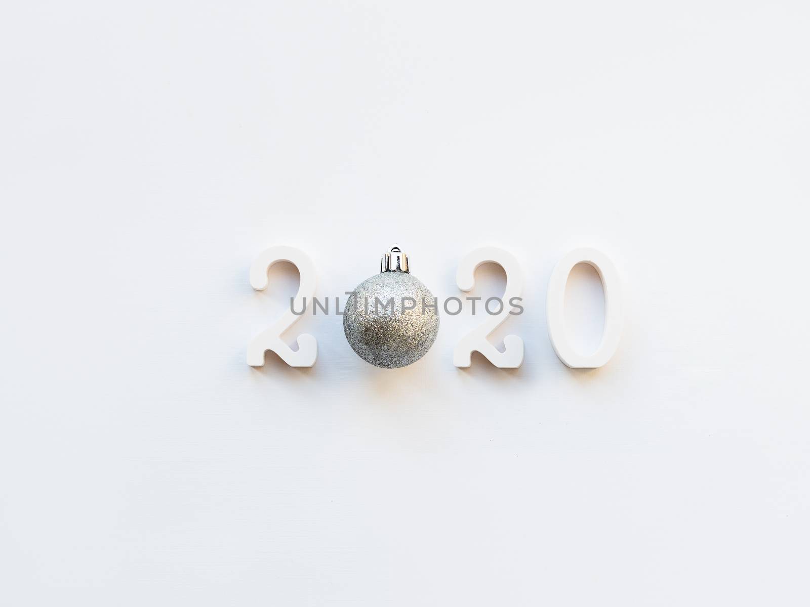 New Year 2020 background with silver ball. Numbers 2020 on white copy space with decorative ball for Christmas tree.