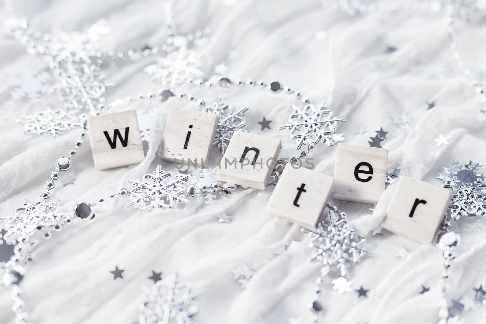 Winter background with decorative sparkling snowflakes and word WINTER.