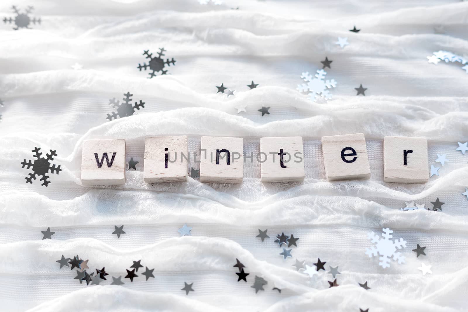 Winter background with decorative sparkling snowflakes and word WINTER.